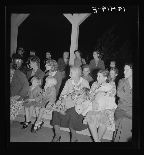 Mothers on the sidelines, watching the Halloween party. Shafter migrant camp, California