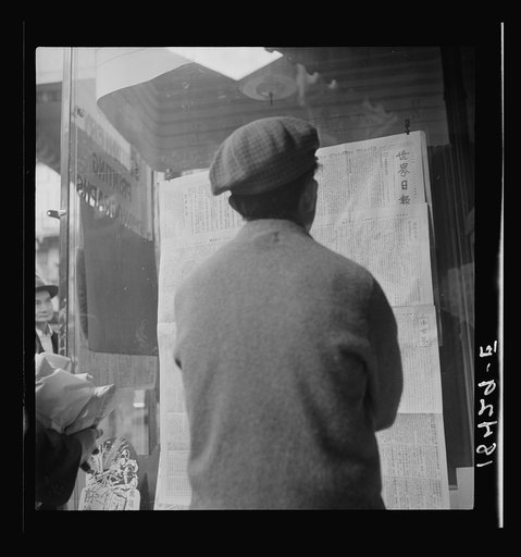 San Francisco Chinaman reading news of surrender of Canton to Japanese.  San Francisco, California