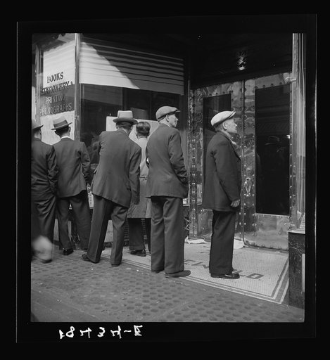 In front of the local paper of San Francisco's Chinatown Chinese read news of the surrender of Canton to the Japanese. Most of San Francisco's Chinese are Cantonese