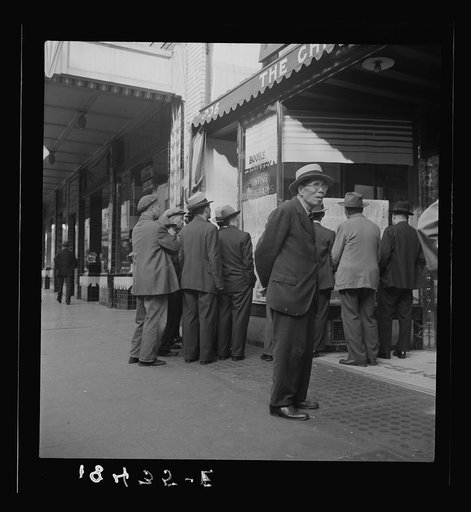 In front of the local paper of San Francisco's Chinatown Chinese read news of the surrender of Canton to the Japanese. Most of San Francisco's Chinese are Cantonese