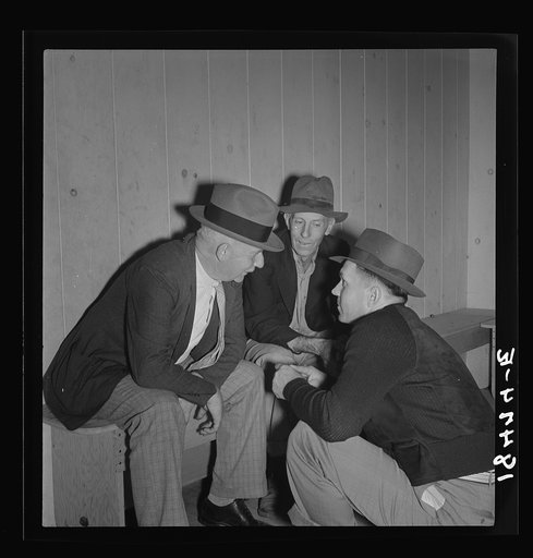 Camp manager, migratory worker, and visitor to the camp in discussion. Shafter camp for migrants, California