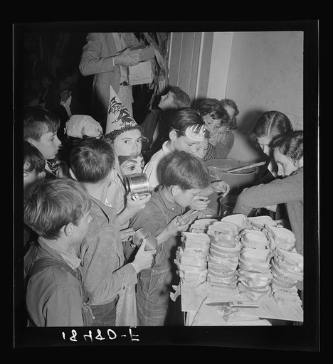 The children crowd and push to reach the refreshments at Halloween party in Shafter migrant camp. California