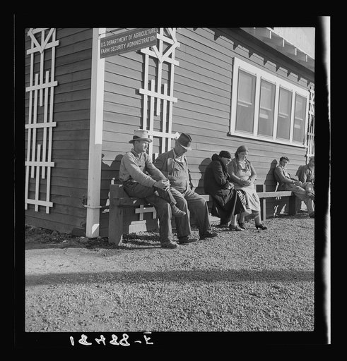 Lineup outside of Farm Security Administration grant office (relief to farm laborers) early in the morning, before the office has opened. Tulare, California