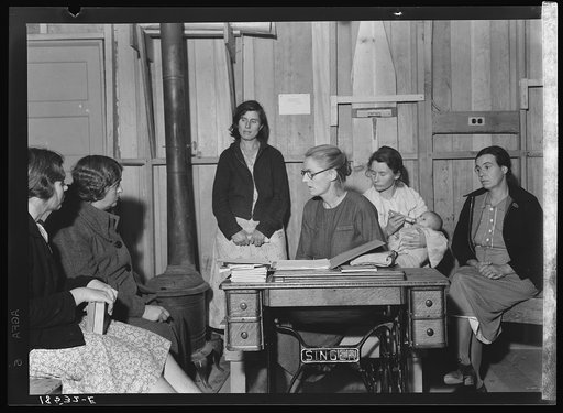 Meeting of the Mothers' Club in Arvin camp for migrant workers, a Farm Security Administration (FSA) camp. The discussion this evening centers on the possibility of buying kerosene oil in large quantities and distributing it cooperatively in camp, to cut costs. Kerosene is used both for cooking and 