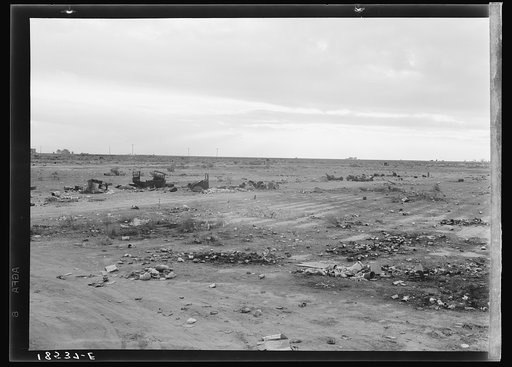 The last frontier. Kern County, California. No water, no shade, no sanitation for the families who camp here during the potato harvesting season. When the season is over they move on. The tin cans and rubbish remain