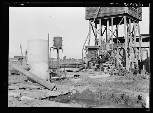 This pumping plant for irrigation is powered by a natural gas engine which operates at about half the cost of electricity. Tulare County, California.  Butane (natural gas in tanks) as a source of power on small farms is in Tulare, Kern, San Luis Obispo, and Santa Barbara Counties, California