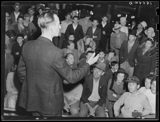 Street meeting at night in Mexican town outside of Shafter, California. Organizer for United Cannery Agricultural Packing and Allied Workers of America (Congress of Industrial Organizations-CIO) talks to mixed crowd. The strike failed