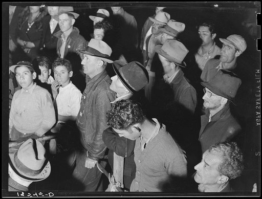 Street meeting at night in Mexican town outside of Shafter, California. Organizer for United Cannery Agricultural Packing and Allied Workers of America (Congress of Industrial Organizations-CIO) talks to mixed crowd. The strike failed