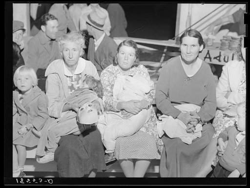 Mothers on the sidelines watch the Halloween party at Shafter migrant camp, California