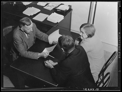 Night meeting in the Farm Security Administration (FSA) office, Rural Rehabilitation Division, Visalia, Tulare County, California. 144 families have applied for Farm Purchase Loans under the Farm Tenancy Act, passed by Congress in 1937. Ten applicants from this region of four counties will be finall