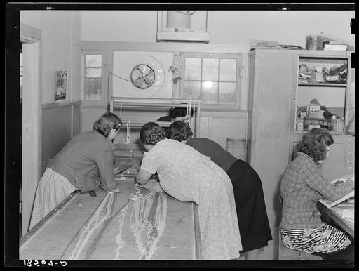 Untitled photo, possibly related to: In the sewing room, migrant women are instructed in rug-making. Shafter camp for migrants (Farm Security Administration-FSA), California. Recreational, educational, cooperative activities in the camp are aided by Work Projects Administration instructors assigned 