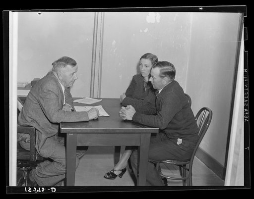Night meeting in the Farm Security Administration (FSA) office, Rural Rehabilitation Division, Visalia, Tulare County, California. 144 families have applied for farm purchase loans under the Farm Tenancy Act, passed by Congress in 1937. Ten applicants from this region of four counties will be finall