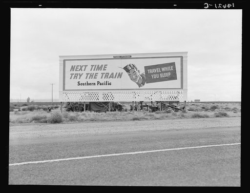 Untitled photo, possibly related to: Billboard along U.S. 99 behind which three destitute families of migrants are camped. Kern County, California