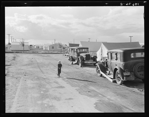 Looking from the camp to adjoining tract where the Farm Security Administration (FSA) has just completed forty homes to be occupied by low income workers. These homes represent a first step in stabilization of this group. Rent is eight dollars and twenty cents monthly, which includes gas and electri