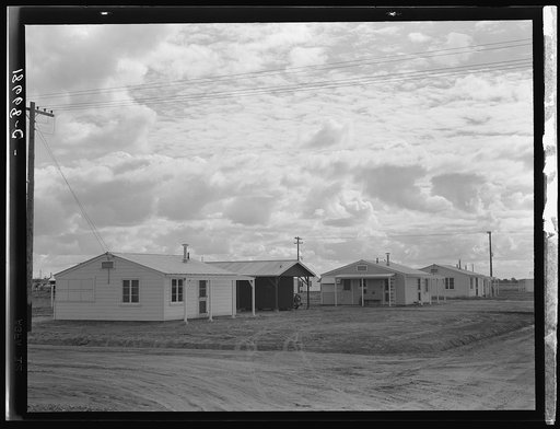 Looking from the camp to adjoining tract where Farm Security Administration (FSA) has just completed forty homes to be occupied by low income workers. These homes represent a first step in stabilization of this group. Rent is eight dollars and twenty cents monthly, which includes gas and electricity