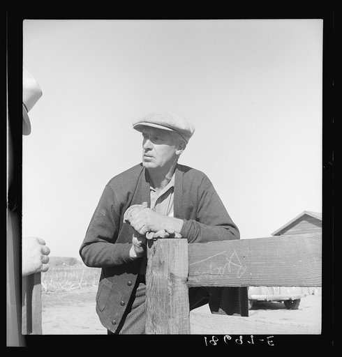 Near Stockton, California. Rehabilitation client, an ex-carpenter, talking over fence with county supervisor