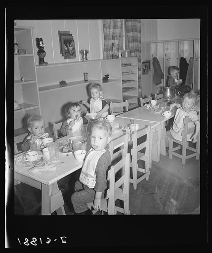 Lunchtime for young migrants at Shafter Camp, California. The nursery school for migrant children is conducted in camp under nursery school teachers trained by WPA (Work Projects Administration), and assigned to work in the camp under WPA project