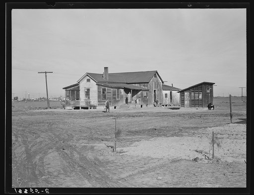 Untitled photo, possibly relatd to: Outskirts of Firebaugh. West side of San Joaquin Valley, California. Six families with twenty-two children live in this house. Cotton workers: "He's good (the boss). He lets us live here without paying rent."