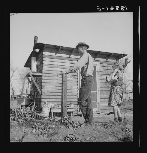Untitled photo, possibly related to: Madera County, family from near Dallas, Texas. Rent is five dollars a month. "There's no future here. I've been following the work (migratory labor) but there's no chance for a fellow to get a holt hisself in this country. The last job I had is tractor driving fo