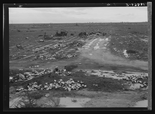 Untitled photo, possibly related to: Kern County. Debris left out on the flats where squatters' camp stood during work season. These are common sights after the migrants have left