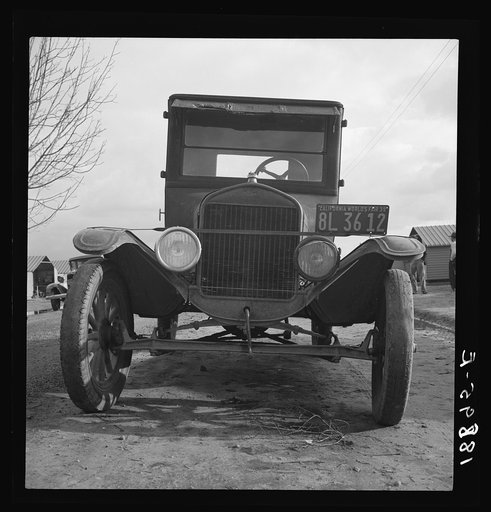 In Farm Security Administration migratory labor camp at Farmersville, California. Model T Fords still carry migrants