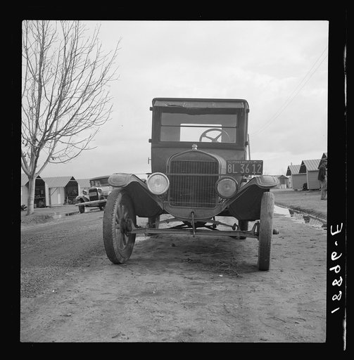 Untitled photo, possibly related to: In Farm Security Administration migratory labor camp at Farmersville, California. Model T Fords still carry migrants