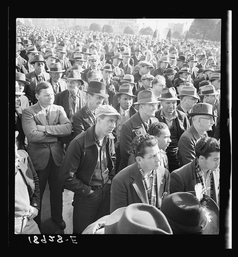 Listening to speeches at mass meeting of Works Progress Administration (WPA) workers protesting congressional cut of relief appropriations. San Francisco, California
