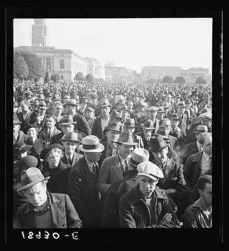 Listening to speeches at mass meeting of Works Progress Administration (WPA) workers protesting congressional cut of relief appropriations. San Francisco, California