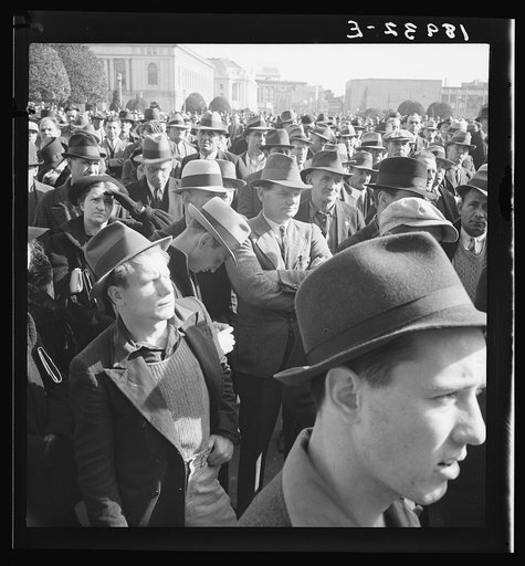 Listening to speeches at mass meeting of Works Progress Administration (WPA) workers protesting congressional cut of relief appropriations. San Francisco, California