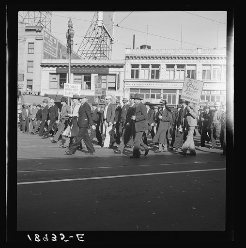 Mass meeting of Works Progress Administration (WPA) workers parading up Market Street. San Francisco, California. The meeting was held in protest to cuts make by Congress in relief appropriations
