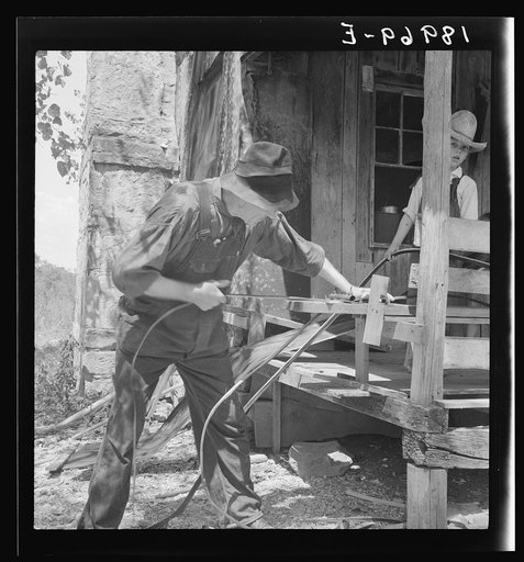In Arkansas Hills (Ozarks) near Seligman, Missouri, splitting hickory for chair-bottoms. His father before him and his son after him make furniture for a living