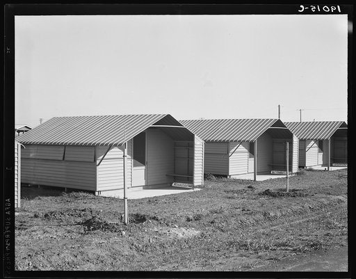 United States government camp for migrant workers (Farm Security Administration-FSA), Westley, California. Pre-fabricated steel shelters replace the use of tents and tent platforms in this newly constructed camp