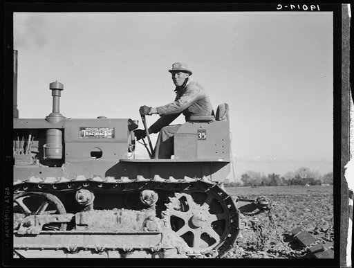 Untitled photo, possibly related to: West side of San Joaquin Valley, California. Caterpillar diesel type tractor is common in California. Only very large-scale operations can afford this type. Cultivating potato-fields