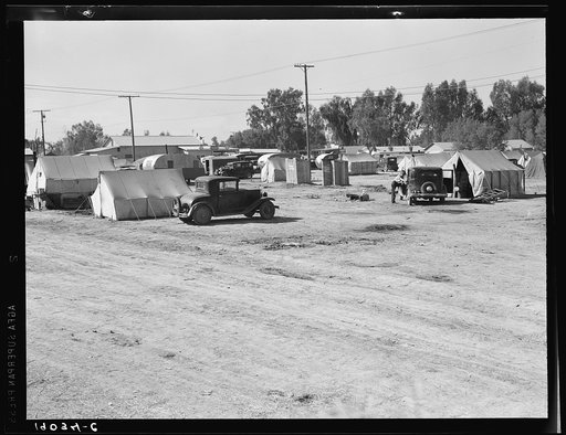 Near Holtville, Imperial Valley, California. Migratory labor housing during carrot harvest. This field owned by proprietor of adjoining grocery store who allows workers to camp here rent-free. Approximately sixty families were living in camp
