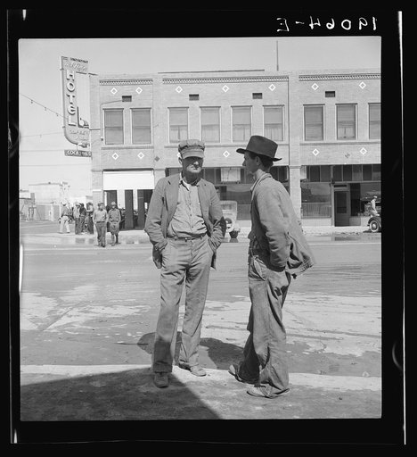 Calipatria, Imperial Valley. Idle pea pickers discuss prospects for work. California