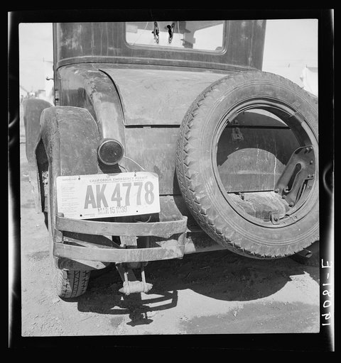 Temporary auto license. A common sight in migratory labor camps. Many enter California after cotton picking in Arizona without sufficient money to buy license plates. California