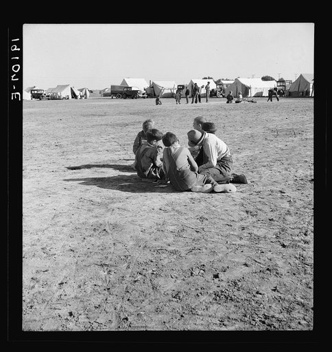 Marble time in Farm Security Administration (FSA) migratory labor camp (emergency). Plenty of space to play and plenty of companions for the children during pea harvest. Near Calipatria, Imperial Valley. California