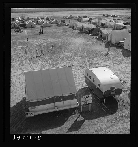 Farm Security Administration (FSA) migratory labor camp. Emergency camp was established to meet the needs of migratory families during the spring pea harvests. 155 families were living here at the time photograph was made. Shows office, playground, and trailer which was built for living quarters and