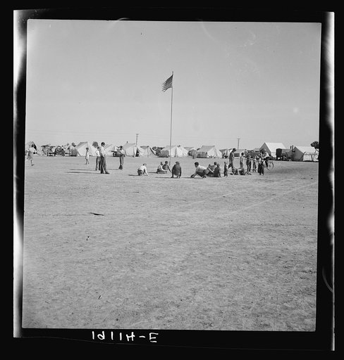 Marble time in Farm Security Administration (FSA) migratory labor camp (emergency.) Plenty of space to play and plenty of companions for the children during pea harvest. Near Calipatria, Imperial Valley, California