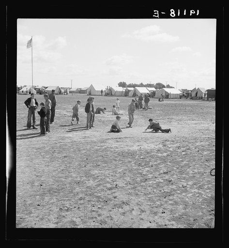 Untitled photo, possibly related to: Marble time in Farm Security Administration (FSA) migratory labor camp (emergency.) Plenty of space to play and plenty of companions for the children during pea harvest. Near Calipatria, Imperial Valley, California