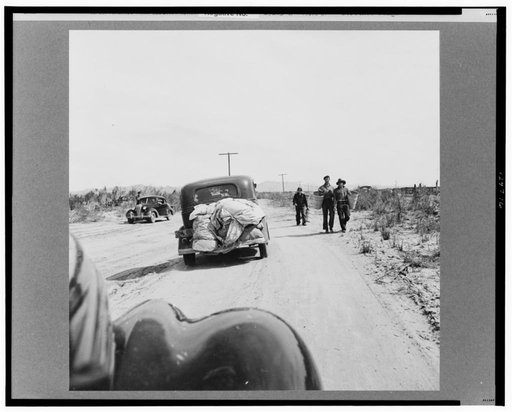 Migratory family arriving at grower's camp for pickers. Car bears Wyoming license, the probable state of origin of the family. Imperial Valley, California