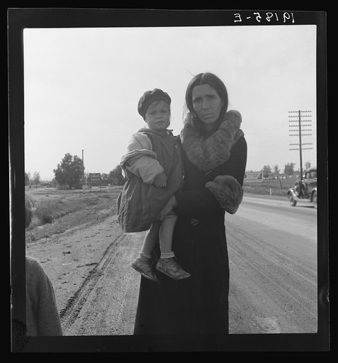 On U.S. 99. Near Brawley, Imperial County. Homeless mother and youngest child of seven walking the highway from Phoenix, Arizona where they picked cotton. Bound for San Diego, where the father hopes to get on relief "because he once lived there."