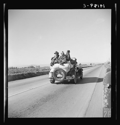 Untitled photo, possibly related to: Eight related persons just arriving in this roadster from Texas. In search of employment as pea pickers. On U.S. 80. Imperial Valley, California