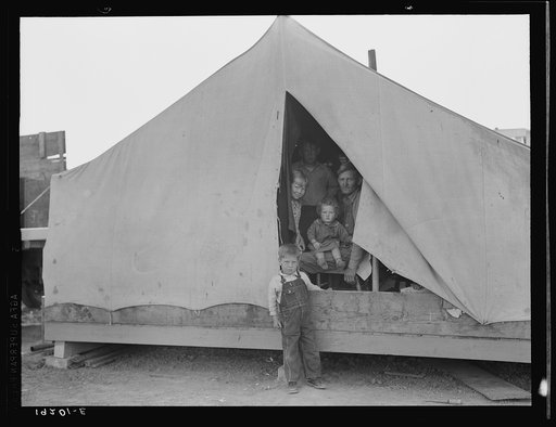 Brawley, Imperial Valley. In Farm Security Administration (FSA) migratory labor camp. Family of mother, father and eleven children, originally from near Mangrum, Oklahoma, where he had been tenant farmer. Came to California in 1936 after the drought. Since then has been traveling from crop to crop i