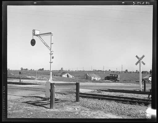 Migrants' tents are a common sight along the right of way of the Southern Pacific. Near Fresno, California