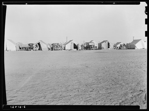 Farm Security Administration (FSA) emergency migratory labor camp. Row of tents, homes of pea pickers seem across recreational grounds. Near Calipatria, Imperial Valley, California