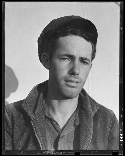 Son-in law of migratory family in Farm Security Administration (FSA) labor camp. Calipatria, Imperial Valley, California