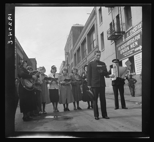 At Minna Street the army forms a semi-circle and sings to attract a crowd. Salvation Army, San Francisco, California