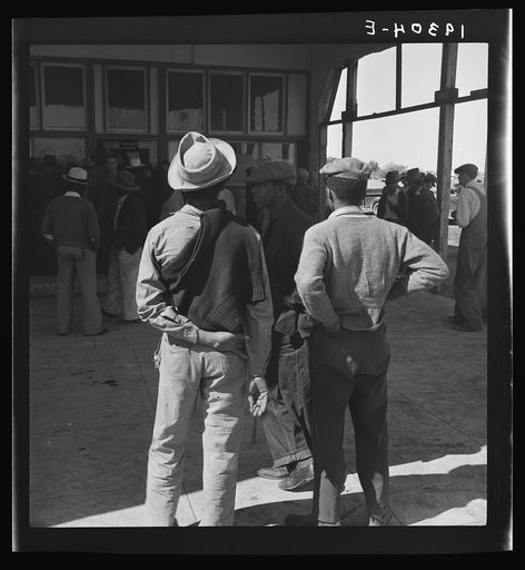 Outside the Farm Security Administration (FSA) grant office during the pea harvest. Calipatria, California. During spring of 1938 for the first time, the labor surplus had grown so large that relief grants were necessary even during the peak of harvest. Colored migrants are becoming more numerous th