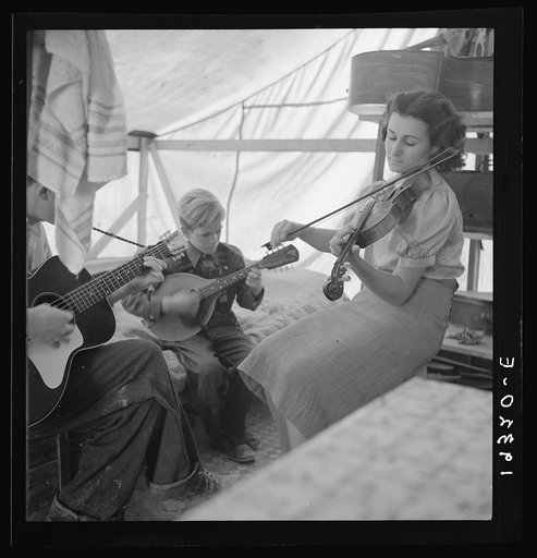 Migrant family from Arkansas playing hill-billy songs. Farm Security Administration emergency migratory camp. Calipatria, California